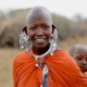 a woman smiling with a man behind her