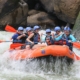 people riding orange kayak on river during daytime