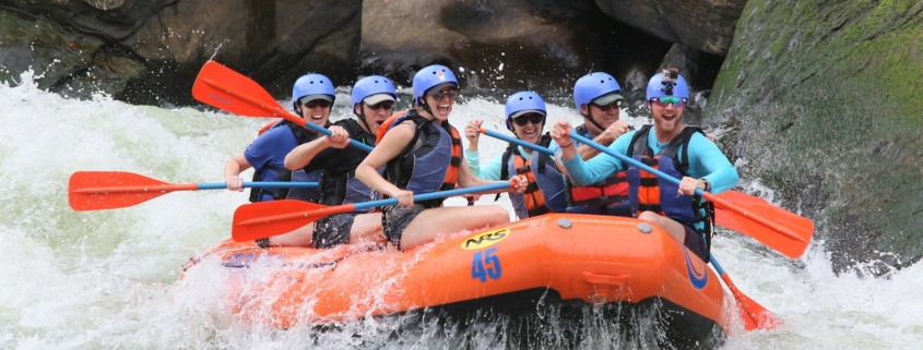 people riding orange kayak on river during daytime