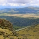 a view of a valley with mountains in the background